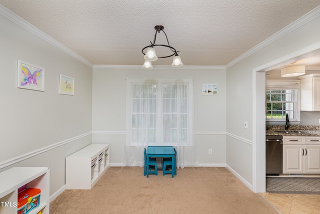 dining space featuring a textured ceiling, ornamental molding, and light colored carpet