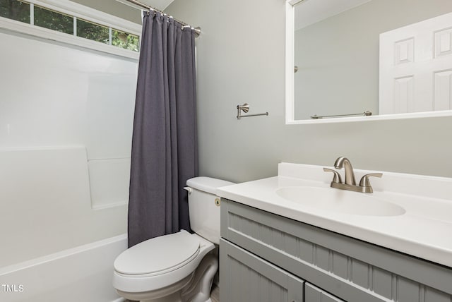 full bathroom with shower / tub combo with curtain, toilet, and vanity