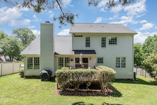 back of house featuring a yard