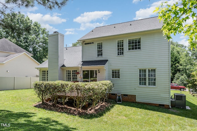 back of house with a lawn