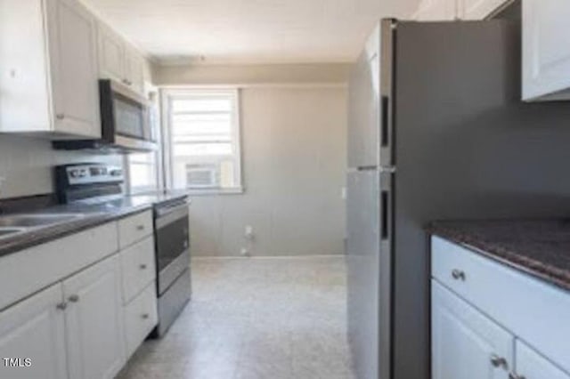 kitchen with stainless steel appliances and white cabinetry