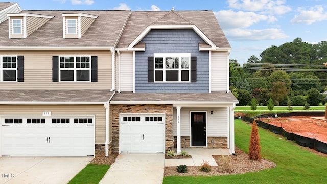 view of front of home with a garage and a front lawn