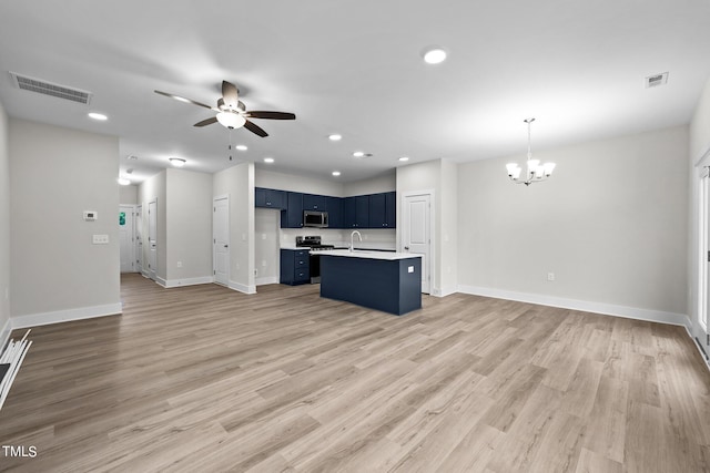 kitchen featuring ceiling fan with notable chandelier, blue cabinets, hanging light fixtures, stainless steel appliances, and light wood-type flooring