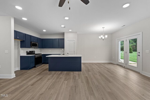 kitchen featuring hanging light fixtures, appliances with stainless steel finishes, blue cabinetry, and light wood-type flooring