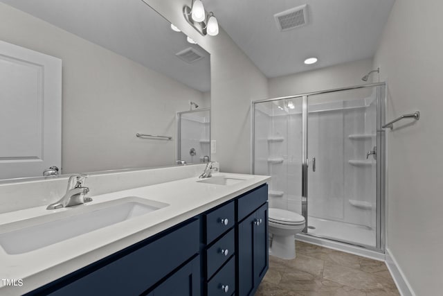 bathroom featuring an enclosed shower, vanity, and toilet