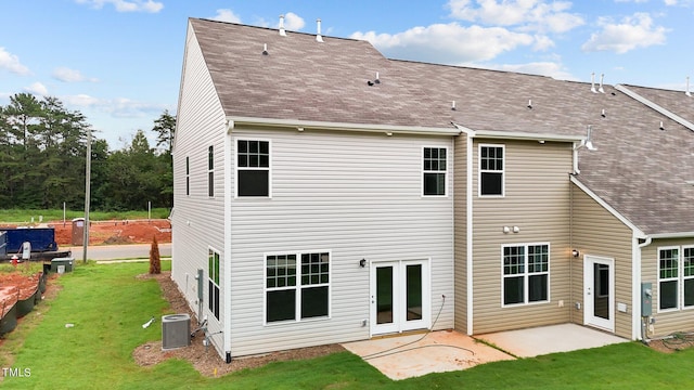 rear view of house featuring central AC unit, a patio, and a lawn