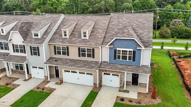 view of property with a garage and a front yard