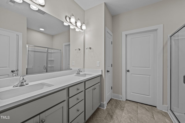 bathroom featuring walk in shower and vanity