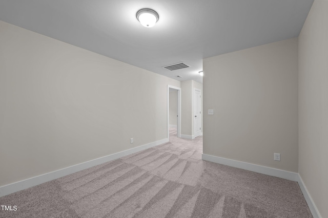 empty room featuring light carpet