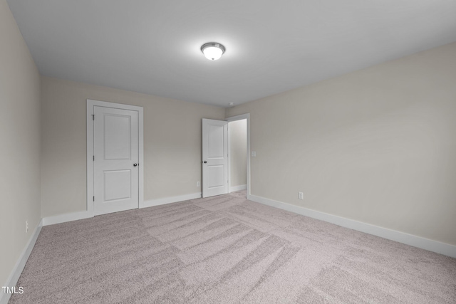 unfurnished room with light colored carpet