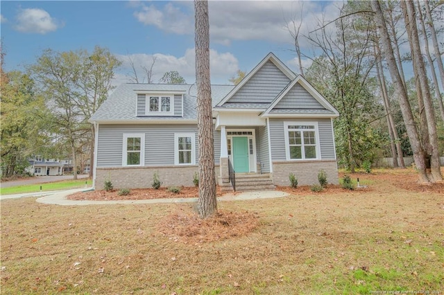 craftsman inspired home with a front lawn
