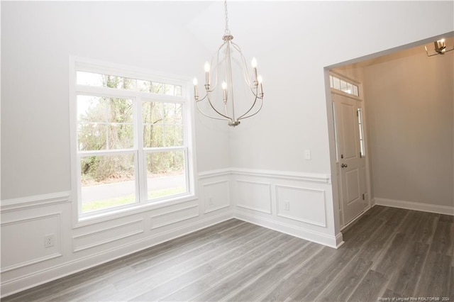 816 Red Hawk Pl, Vass, NC 28394 - unfurnished dining area featuring a chandelier, plenty of natural light, a wainscoted wall, dark wood-style flooring, and a decorative wall