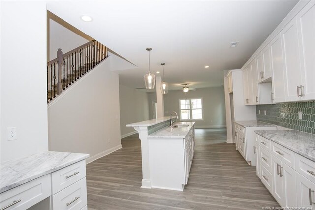 816 Red Hawk Pl, Vass, NC 28394 - kitchen featuring a ceiling fan, white cabinets, light wood-style flooring, an island with sink, and recessed lighting