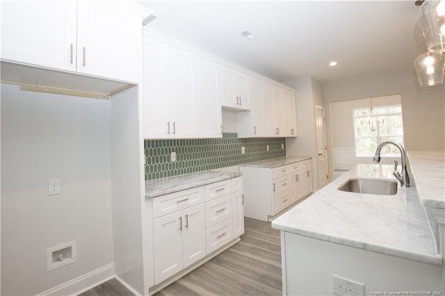 816 Red Hawk Pl, Vass, NC 28394 - kitchen featuring white cabinets, light stone counters, light wood finished floors, backsplash, and recessed lighting