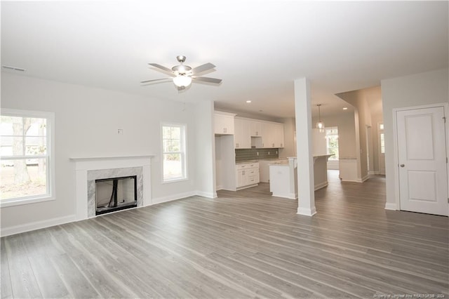 816 Red Hawk Pl, Vass, NC 28394 - unfurnished living room with ceiling fan, light wood-type flooring, a premium fireplace, and recessed lighting