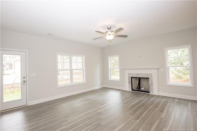816 Red Hawk Pl, Vass, NC 28394 - unfurnished living room featuring wood finished floors, a ceiling fan, and a premium fireplace