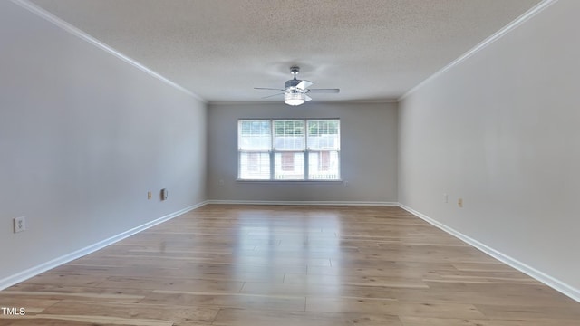 empty room with a textured ceiling, ornamental molding, wood-type flooring, and ceiling fan