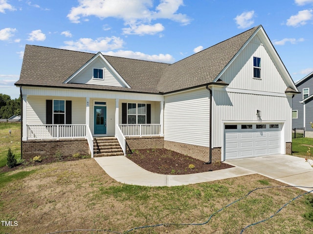 view of front of property featuring a porch, a garage, and a front lawn