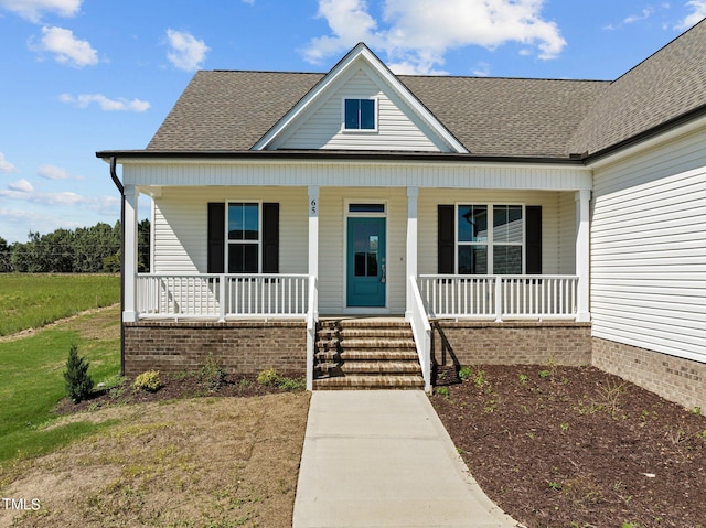 bungalow featuring a front lawn and a porch