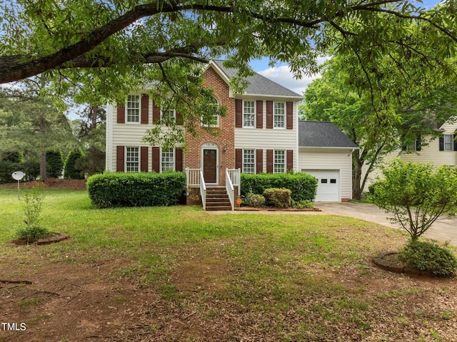 colonial home featuring a front lawn and a garage