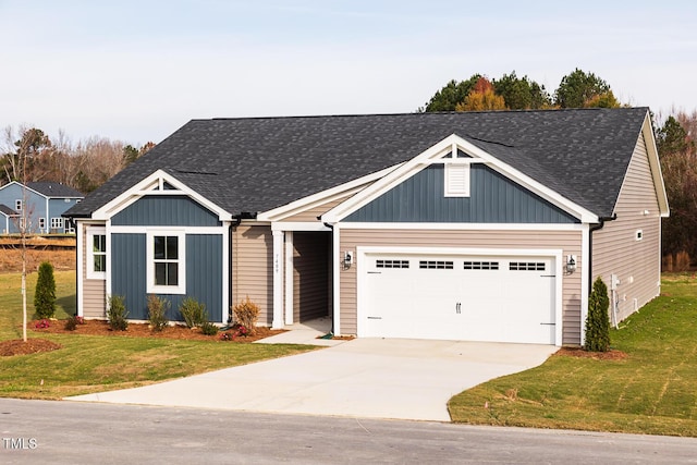 view of front of home with a front yard and a garage