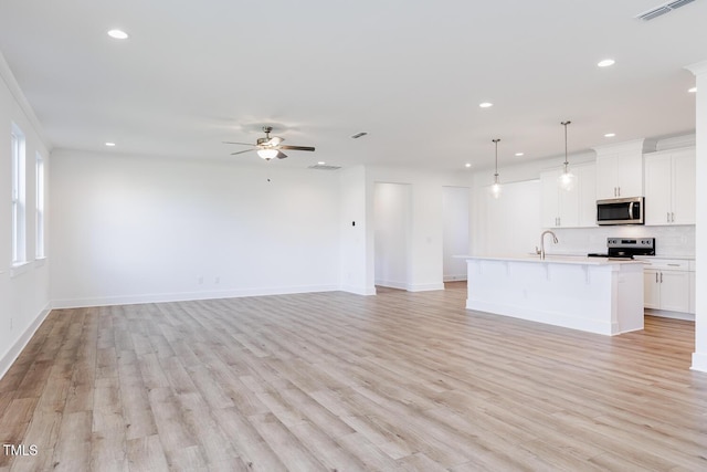 unfurnished living room featuring ceiling fan, light hardwood / wood-style flooring, and sink