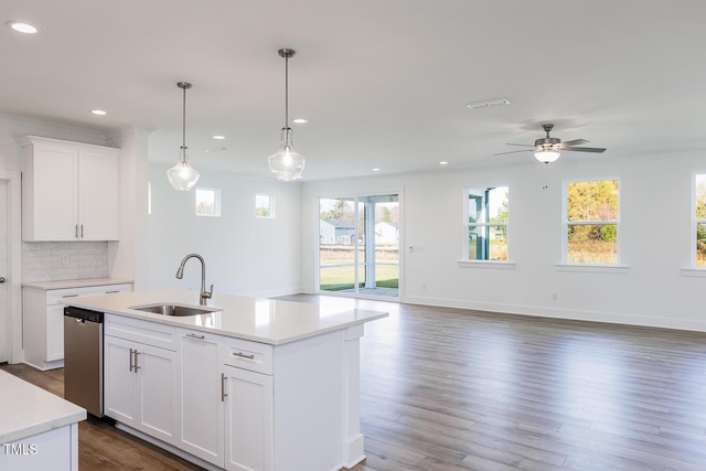 kitchen featuring dishwasher, sink, white cabinets, and a healthy amount of sunlight