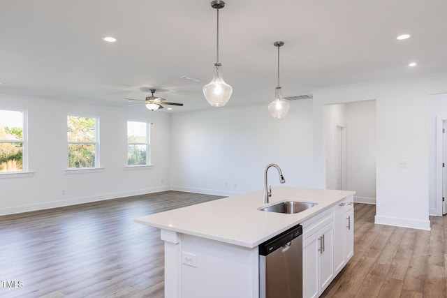 kitchen featuring pendant lighting, dishwasher, a center island with sink, white cabinets, and light hardwood / wood-style flooring