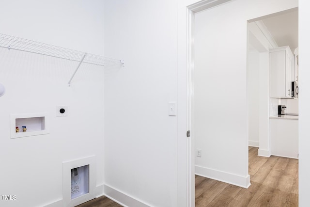 washroom with washer hookup, light hardwood / wood-style floors, and electric dryer hookup