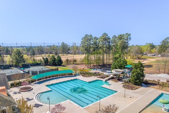 view of pool featuring an outdoor fire pit, a water slide, and a patio area