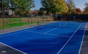 view of tennis court featuring basketball court