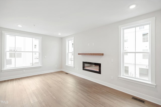 unfurnished living room featuring light wood-type flooring