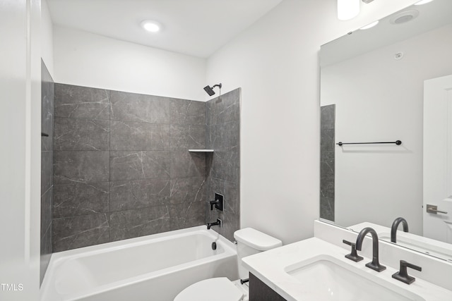 full bathroom featuring tiled shower / bath combo, vanity, and toilet