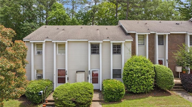 multi unit property featuring a shingled roof