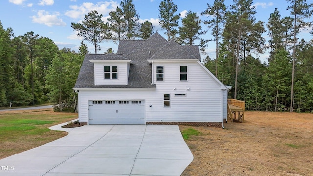 view of home's exterior featuring a lawn, a deck, and a garage