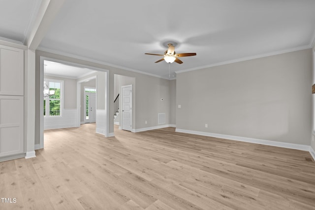 unfurnished living room with ceiling fan, ornamental molding, and light wood-type flooring