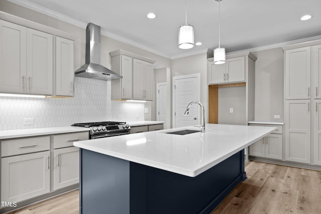 kitchen with light hardwood / wood-style flooring, decorative backsplash, sink, gas stove, and wall chimney range hood