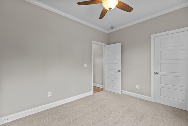 unfurnished bedroom with ceiling fan, ornamental molding, and carpet flooring