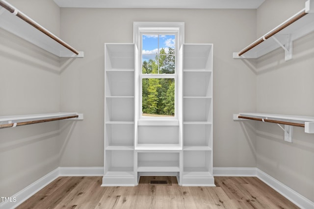 walk in closet featuring light hardwood / wood-style flooring