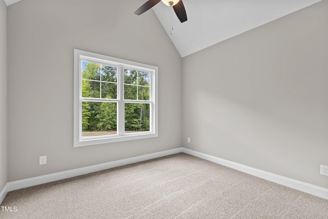 carpeted empty room with ceiling fan, lofted ceiling, and a healthy amount of sunlight