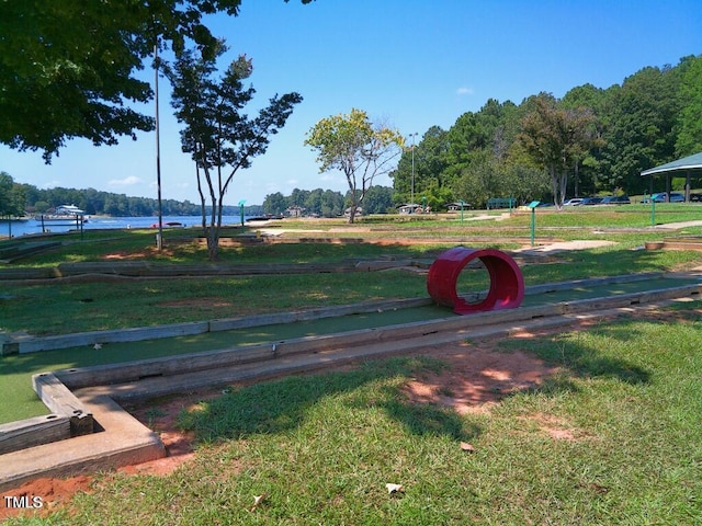 view of property's community with a yard and a water view