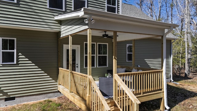 property entrance with roof with shingles and a ceiling fan