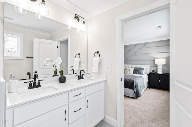 ensuite bathroom featuring crown molding, double vanity, a sink, and connected bathroom