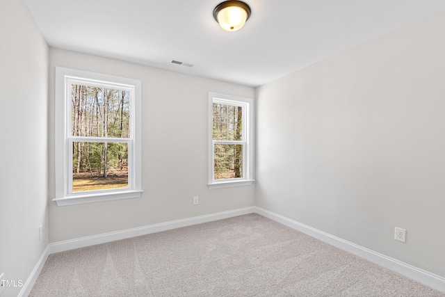 carpeted empty room with baseboards and visible vents