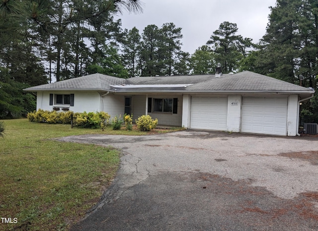 single story home featuring a garage, central air condition unit, and a front lawn