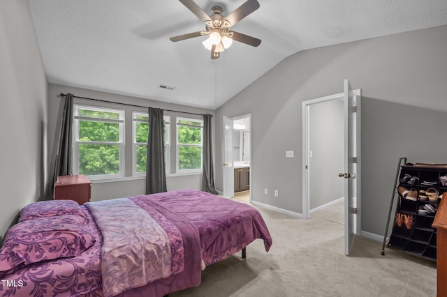 612 Quartz Dr, Durham, NC 27703 - bedroom with lofted ceiling, light colored carpet, baseboards, a ceiling fan, and ensuite bath