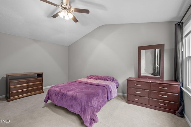 612 Quartz Dr, Durham, NC 27703 - bedroom with light colored carpet, vaulted ceiling, a ceiling fan, and baseboards