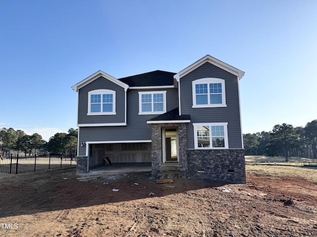 view of front facade with crawl space, driveway, an attached garage, and fence