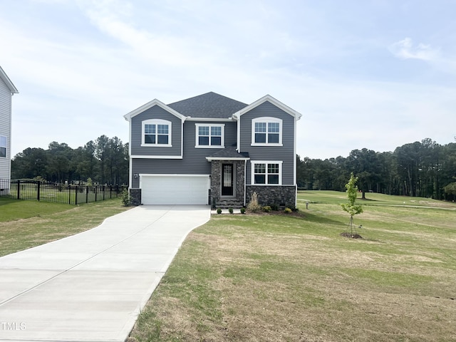 traditional-style house featuring stone siding, concrete driveway, fence, a garage, and a front yard