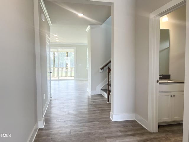 hall with baseboards, crown molding, and dark wood-style floors